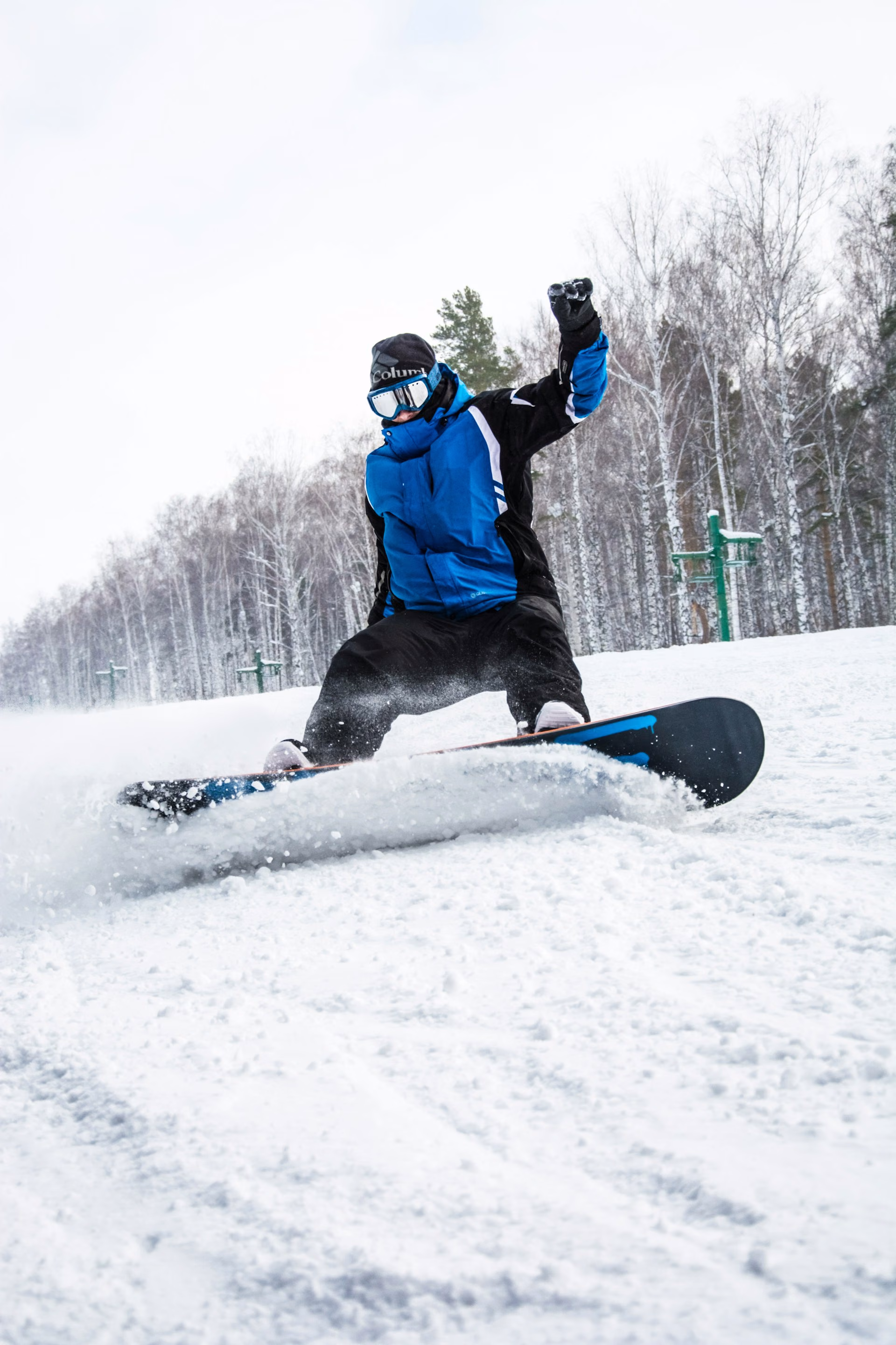 Snowboarder carving a turn through fresh snow