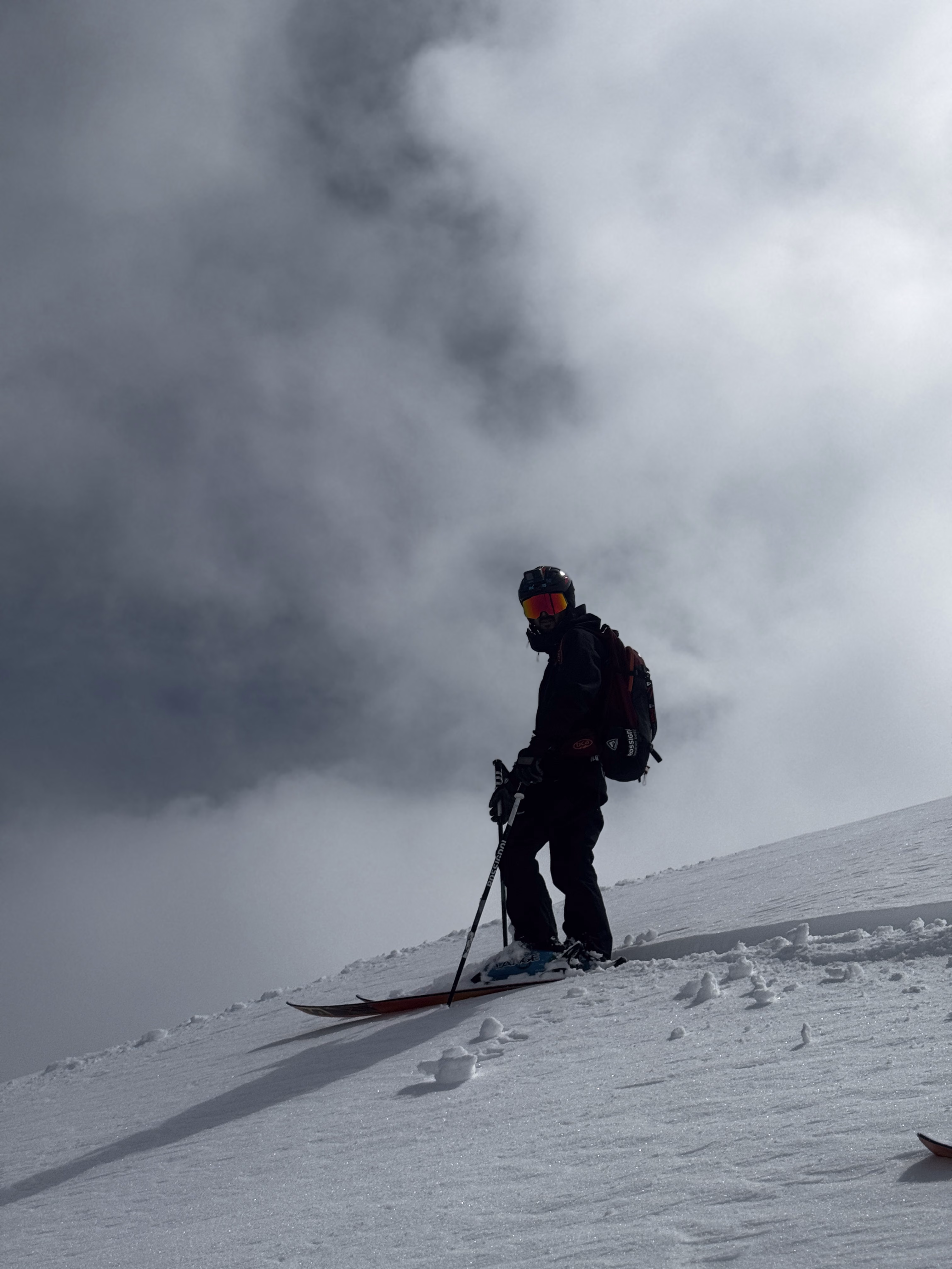 Skier descending through low cloud on a Gulmarg mountainside